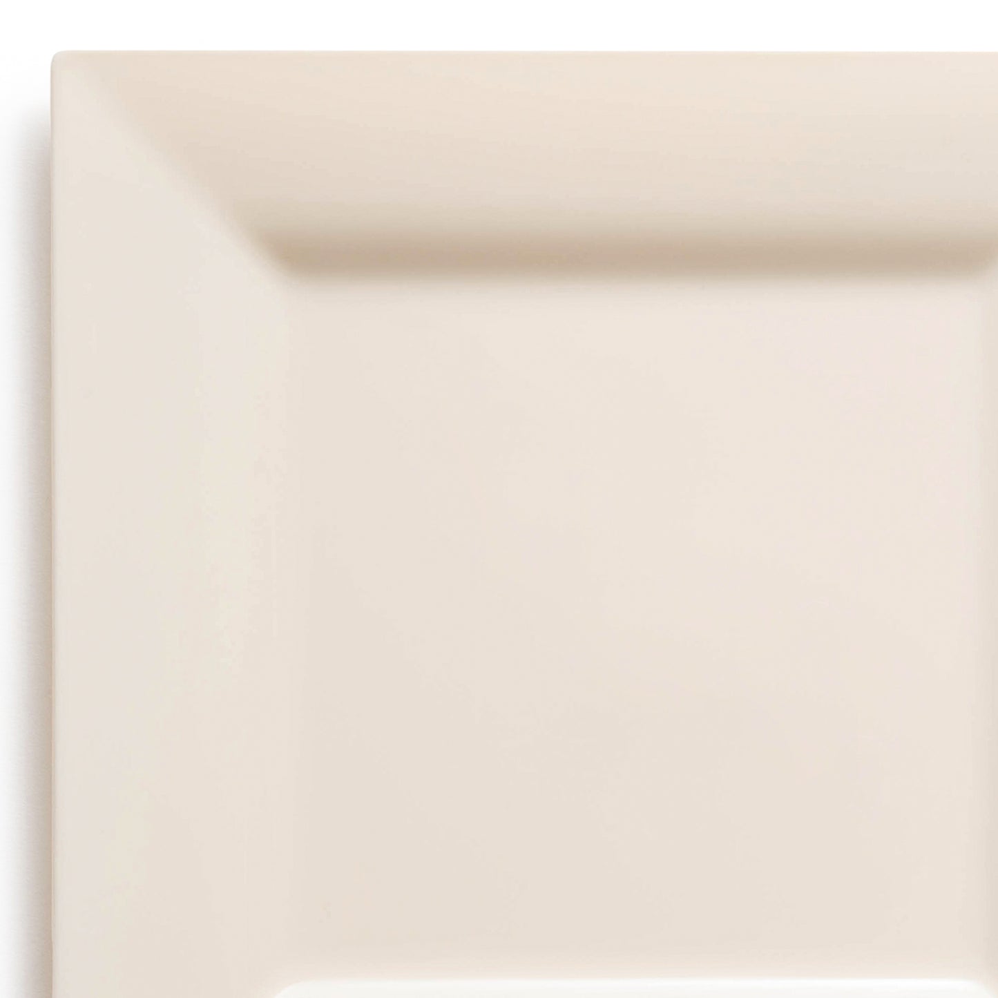 A minimalist, square, white ceramic plate with a smooth surface and a subtle shine. The plate has a slightly raised edge, creating a shallow depth for holding food. It bears resemblance to sleek Ivory Square Disposable Plastic Cake Plates (6.5") and is set against a plain, off-white background.