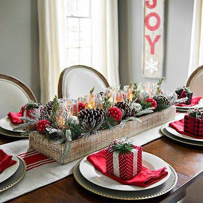 A festive Christmas table setting featuring red and white plates, elegantly arranged for a delightful Christmas dinner.