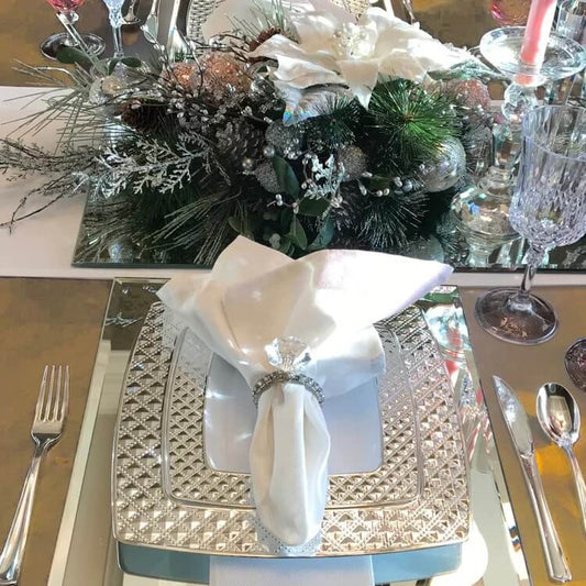 Elegant winter table decor featuring silver and white decorations, creating a sophisticated dining atmosphere.