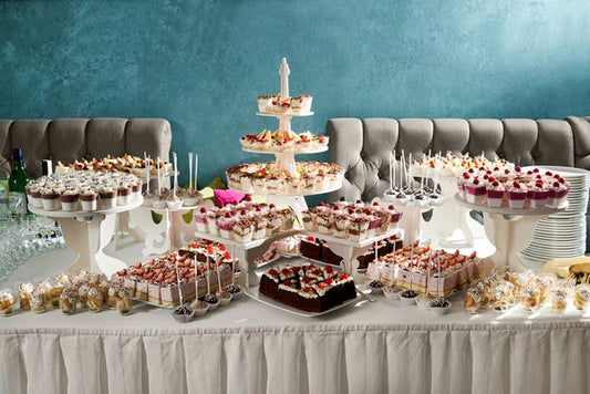 Elegant dessert table featuring stylish mini disposable partyware and an assortment of desserts