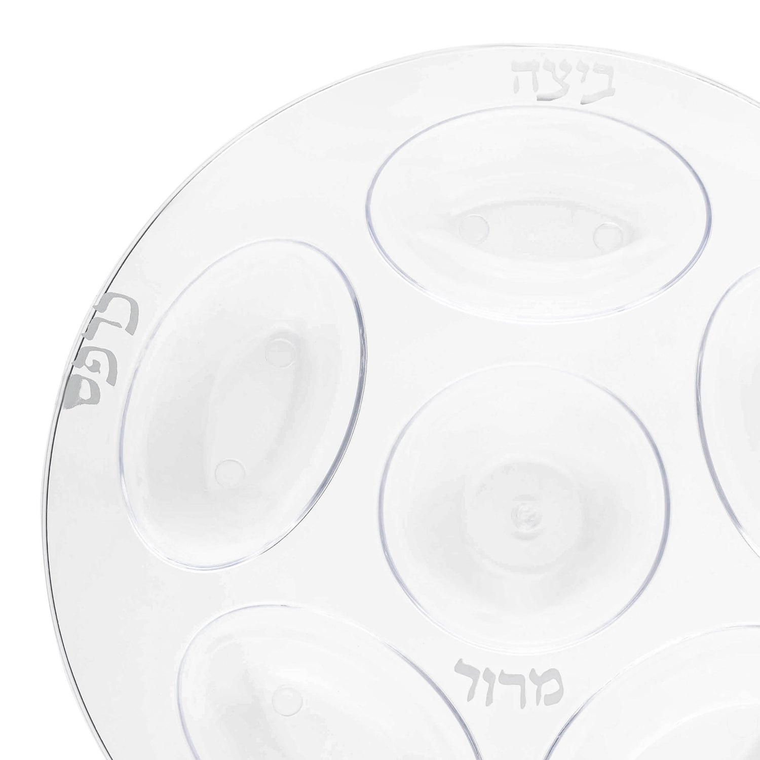 Introducing the Clear with Silver Round Section Tray Plastic Seder Plates (12"): This elegant 12" round Seder plate is made from durable plastic and features six oval indentations, each labeled in legible Hebrew script with traditional Seder items. Perfect for an elegant table setting, it also offers the convenience of a disposable option.