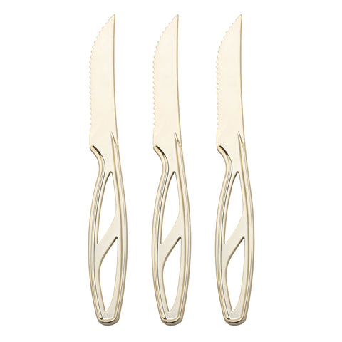 Three gold plastic disposable steak knives with serrated edges and hollow, geometrically-designed handles are aligned vertically against a white background, showcasing the elegance of upscale cutlery.