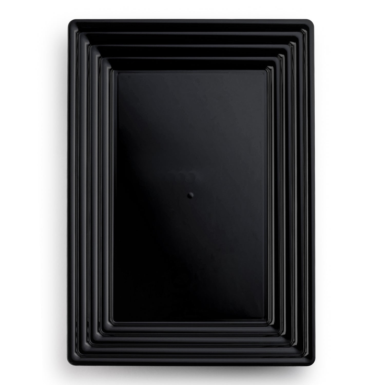 Introducing the 9" x 13" Black Rectangular with Groove Rim Disposable Plastic Serving Trays: a set of sleek, black plastic trays that fit perfectly inside one another, creating a nested appearance. Each tray features a smooth, glossy surface and an elegant groove-designed rim. The largest tray sits at the bottom, with progressively smaller trays stacked neatly within it.